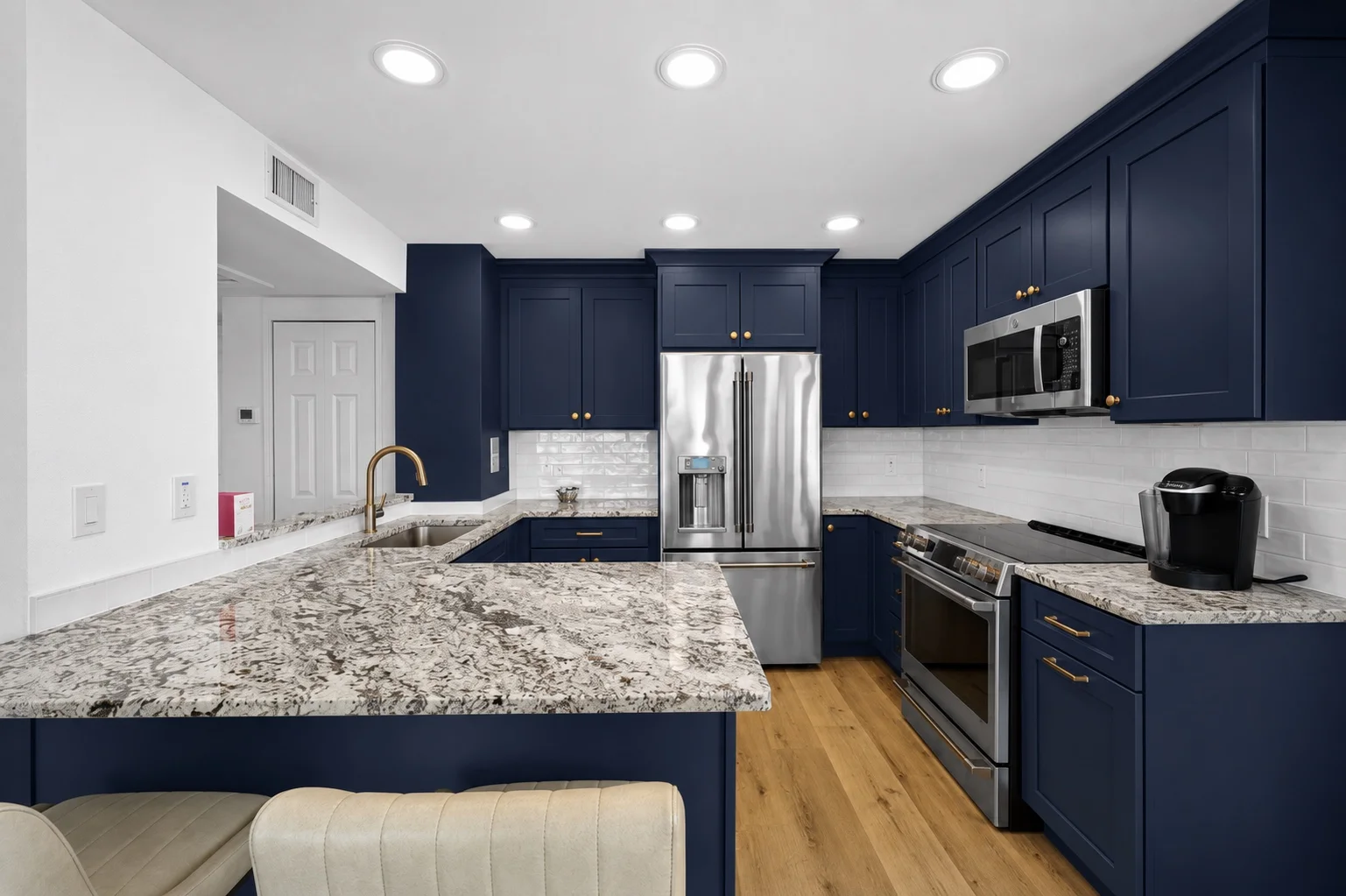 Rich navy blue shaker kitchen cabinets with brass hardware