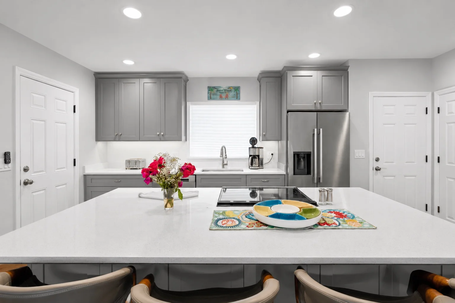 Soft gray shaker kitchen cabinets with a stainless steel refrigerator